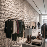 3D concrete wall tiles Kraken used as a feature wall in modern retail design - FLOAT concrete
