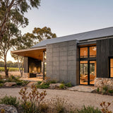 Modern house with concrete wall paneling and glass facade in a natural setting - FLOAT concrete