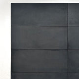 TV accent wall in dark moody concrete adds depth and a dramatic focal point to modern living spaces